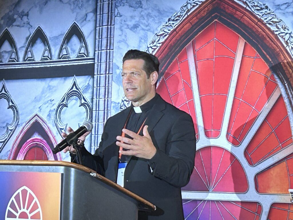 Father Mike Schmitz, director of Youth and Young Adult Ministry for the Diocese of Duluth, Minn., as well as the chaplain for the Newman Center at the University of Minnesota-Duluth, speaks to media at the National Eucharistic Congress in Indianapolis July 18.