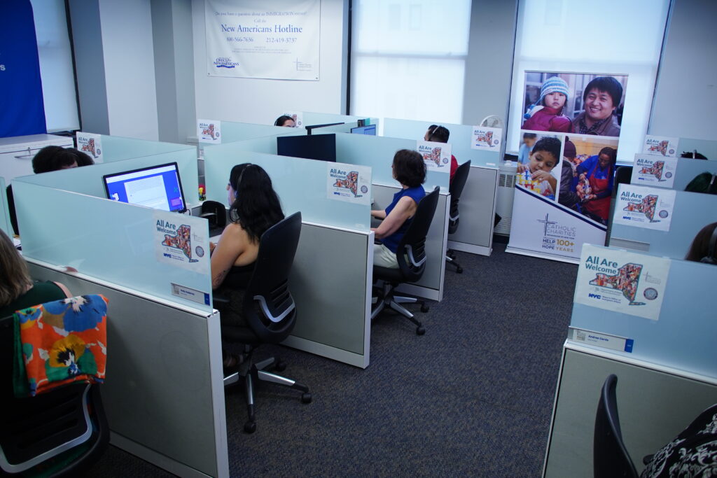 Phone bank volunteers take calls regarding fraud targeting migrants, July 17, 2024.