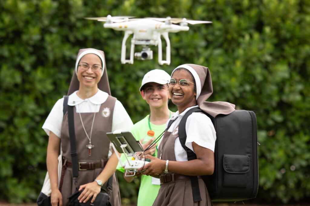 Sisters Mary Martha Cuenca and Rachel Lucia Kotoor operate a drone August 5, 2023, to provide social media coverage of a weeklong series of parallel World Youth Day.