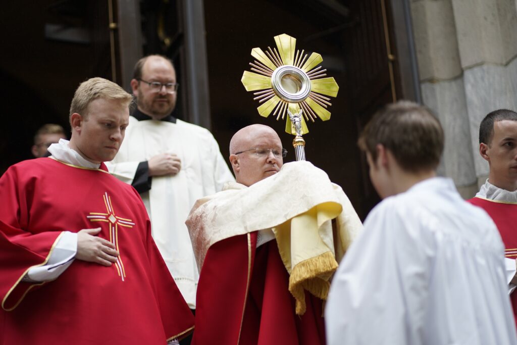 Father Roger Landry, chaplain for the National Eucharistic Pilgrimage, carries a monstrance from St. Mary’s Church in New Haven, Connecticut, at the start of a Eucharistic procession May 18, 2024.