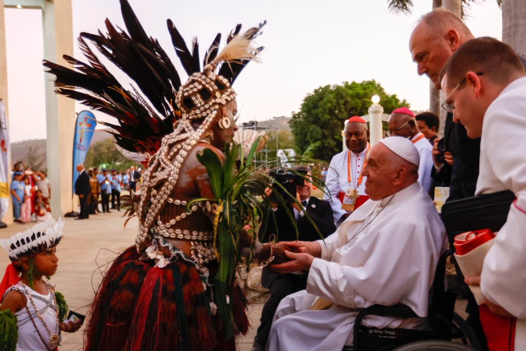 Pope Francis greets a woman in traditional dress upon his arrival at the Shrine of Mary Help of Christians in Port Moresby, Papua New Guinea, September 7, 2024. (CNS photo/Lola Gomez)