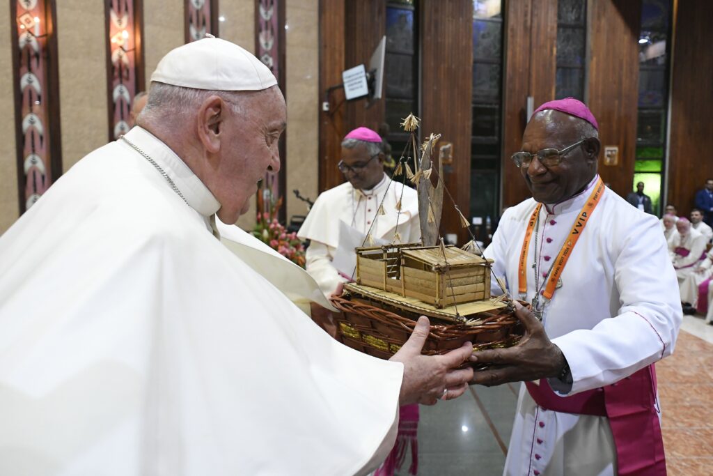 Pope Francis receives a gift from Bishop Otto Separy of Bereina, president of Papua New Guinea's bishops' conference, during a meeting with bishops, priests, deacons, religious, seminarians and pastoral workers at the Shrine of Mary Help of Christians in Port Moresby, Papua New Guinea, September 7, 2024.