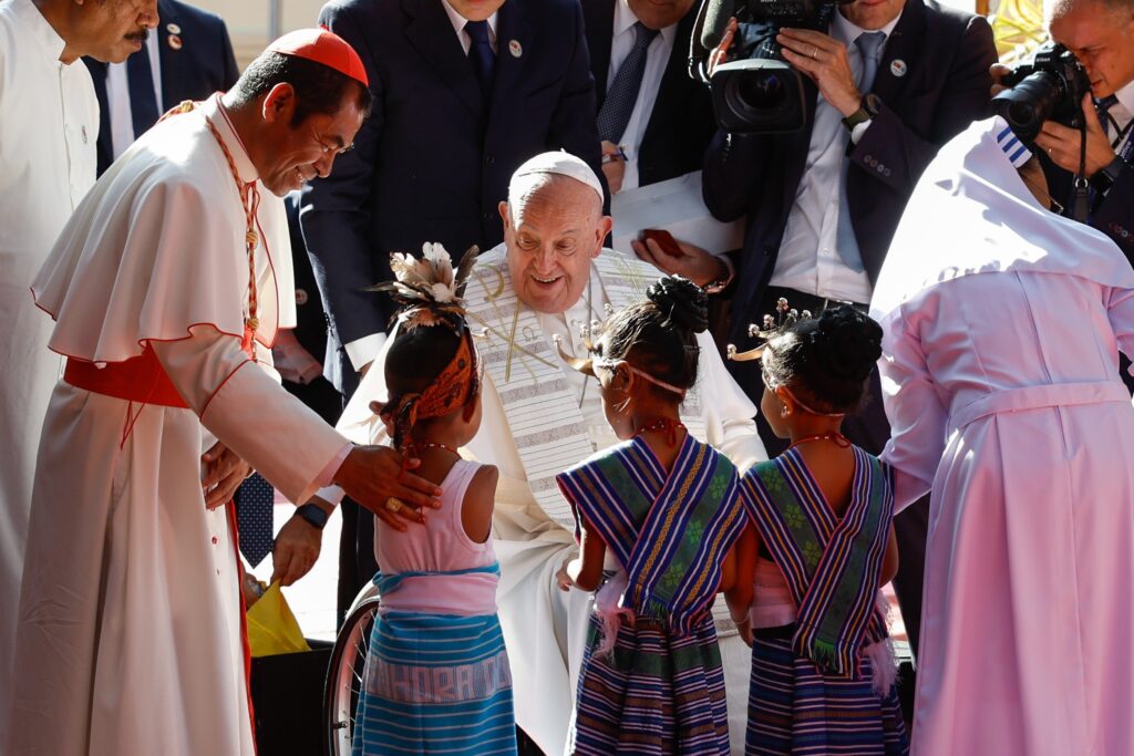 Pope Francis greets children in traditional dress during a visit with children who are seriously ill or have severe disabilities at the Irmas Alma School in Dili, Timor-Leste, September 10, 2024.