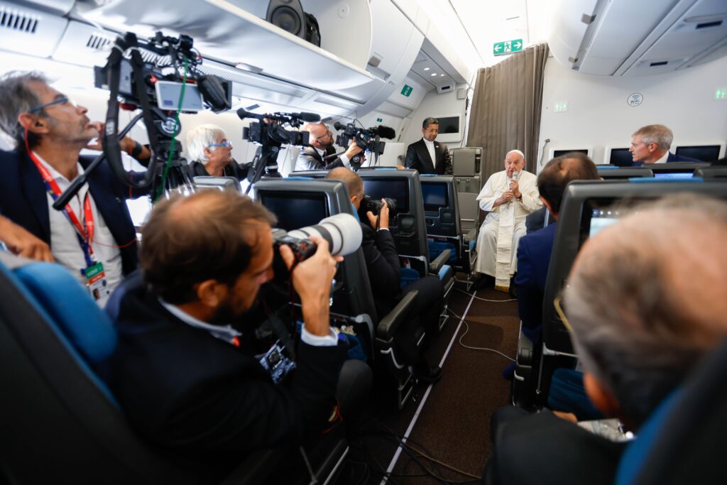 Pope Francis answers a question from a journalist aboard his flight back to Rome September 13, 2024, after visiting Indonesia, Papua New Guinea, Timor-Leste and Singapore. It was his 45th and longest foreign trip.