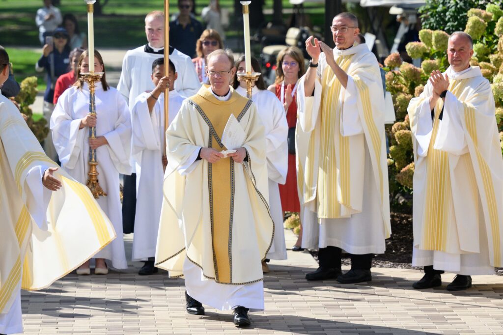 Holy Cross Father Robert A. Dowd acknowledges applause from concelebrants after the Mass celebrating his inauguration as the University of Notre Dame's 18th president in Notre Dame, Indiana, on September 13, 2024.