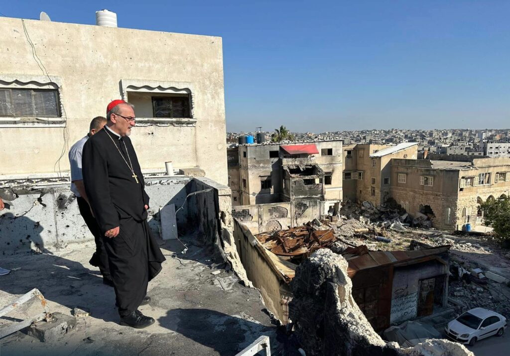 Cardinal Pierbattista Pizzaballa, the Latin patriarch of Jerusalem, walks through the ruins of buildings in Gaza City.