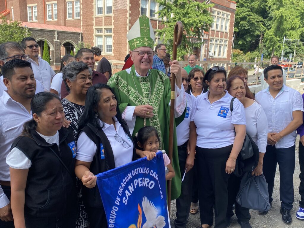 Cardinal Timothy Dolan (center, in green) poses with members of the Grupo de Oracion Catolico Carismatico San Piero at St. Mary’s Church in Kingston on September 1, 2024.