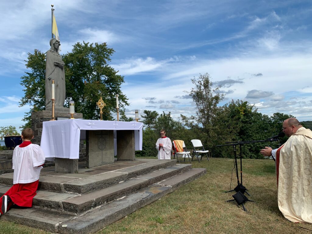 With the Blessed Sacrament exposed atop the outdoor altar of the National Shrine of Our Lady of the Hudson, Father Justin Cinnante, O.Carm., led scores of Catholics in adoration at the Holy Hour ceremony.