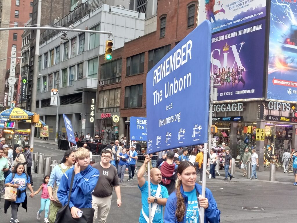 Participants of Relay for Pro-Life approach Father Duffy Square in Times Square on the morning of Saturday, September 7, 2024.