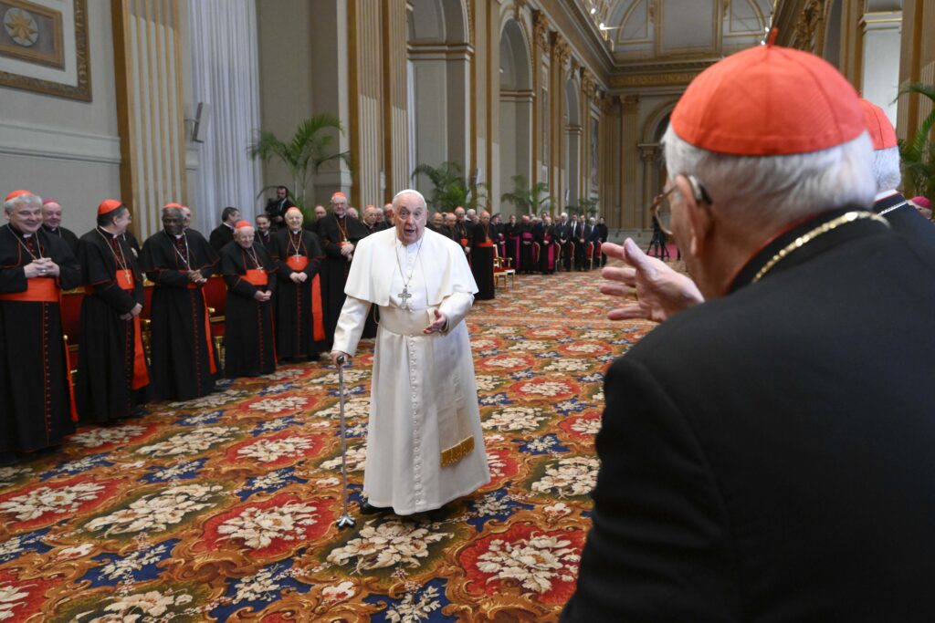 Pope Francis smiles at Cardinal Giovanni Battista Re, dean of the College of Cardinals, as he arrives in the Vatican's Hall of Blessings on December 21, 2023, to give his Christmas greetings to cardinals and top officials of the Roman Curia.