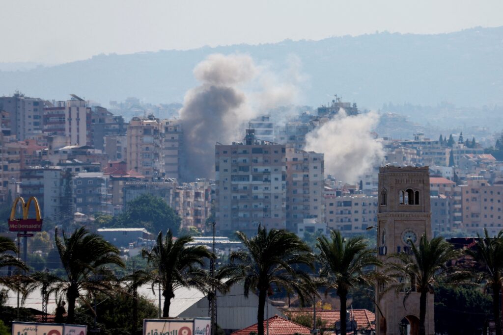 Smoke billows from damaged buildings over southern Lebanon, as seen from Tyre September 25, 2024, following an Israeli airstrike amid ongoing cross-border hostilities between Hezbollah and Israeli forces.