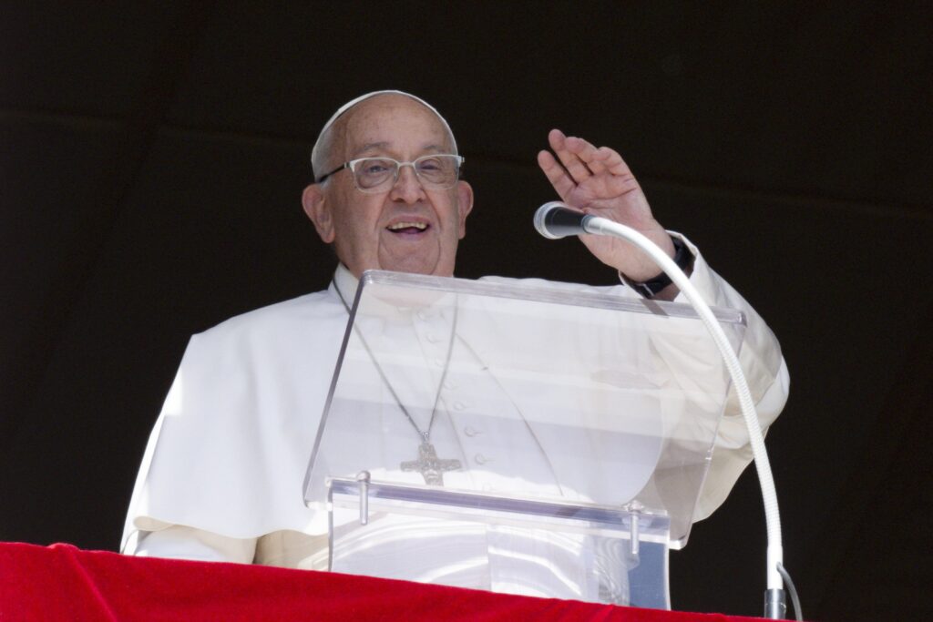 Pope Francis waves to people gathered in St. Peter's Square at the Vatican for the recitation of the Angelus prayer on October 13, 2024.