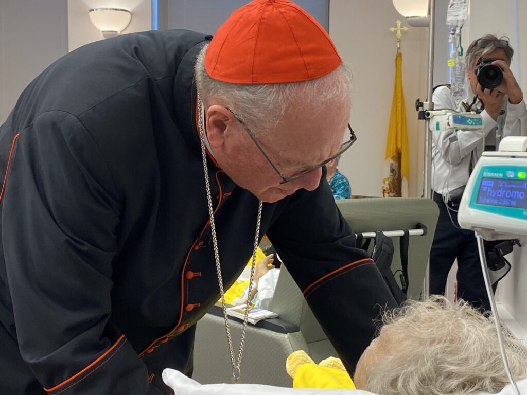 Cardinal Timothy Dolan visits an elderly patient at Calvary Hospital in the Bronx, October 3, 2024.