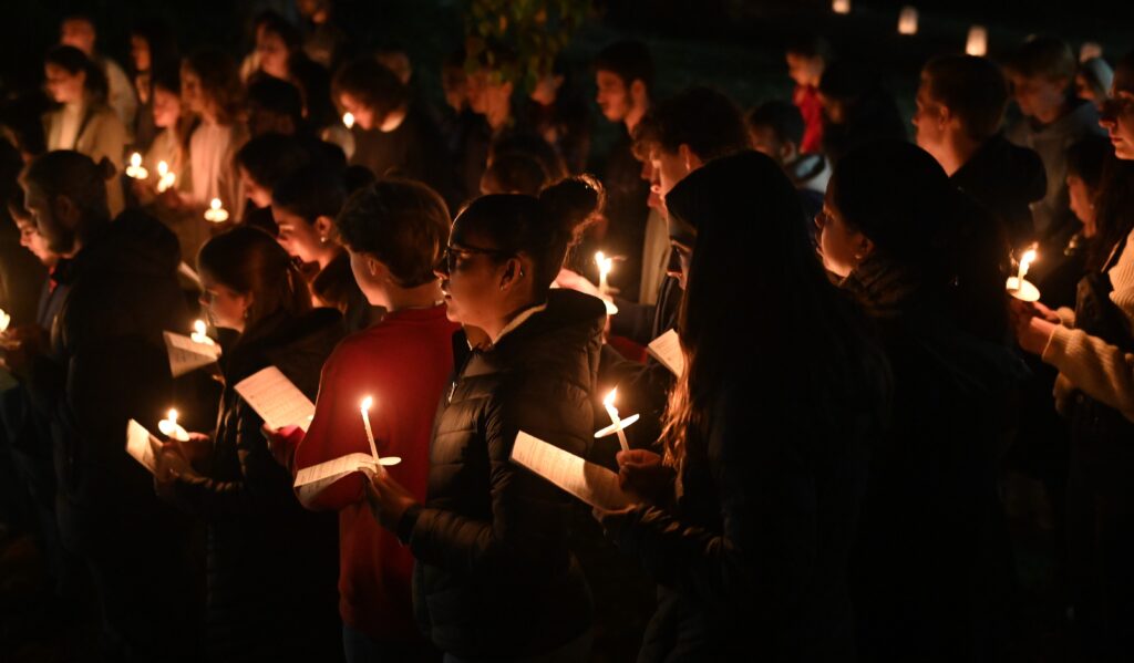 Students participate in a prayer service following a November 2, 2023, All Souls' Day Mass at the Catholic Student Center at the University of Maryland at College Park. Rows of luminarias with the names of deceased family members and friends lined the grounds at the center.