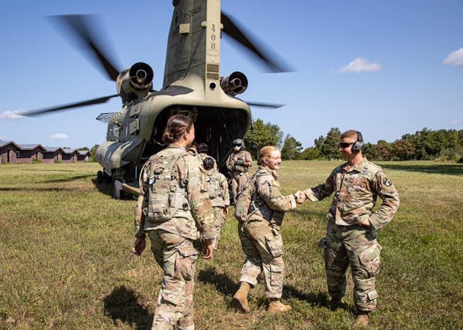 Father Lukasz J. Willenberg (right), a U.S. Army chaplain, greets new recruits in this undated photo.