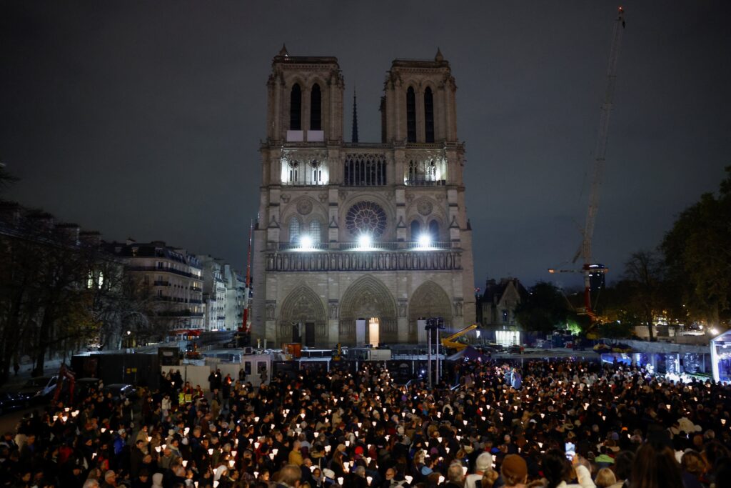 People attend a Marian candlelit procession November 15, 2024, where the Virgin of Paris statue returns to Notre Dame Cathedral in Paris.