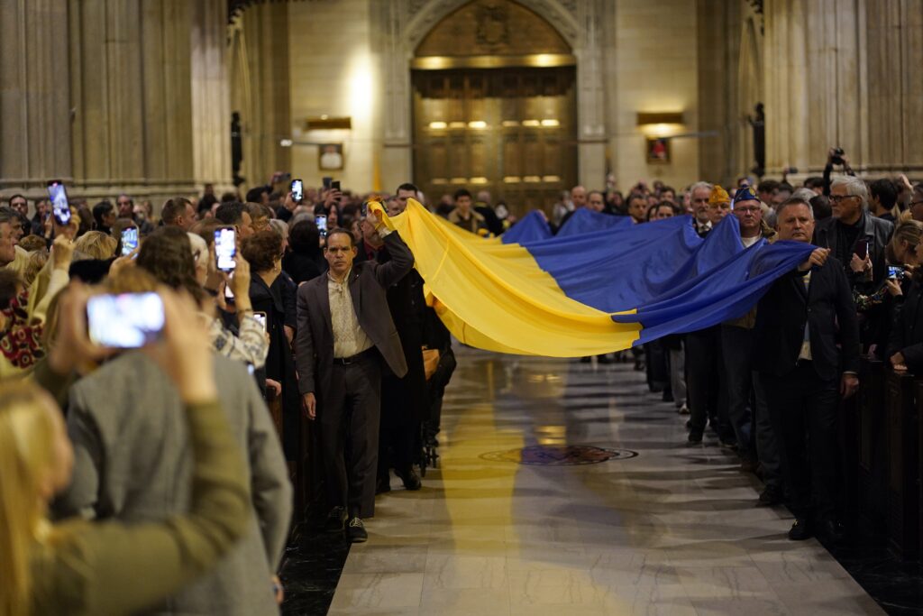 A Ukrainian flag is carried in procession at St. Patrick's Cathedral in New York City November 23, 2024, during a prayer service marking the 91st anniversary of the Holodomor, a famine engineered by Soviet dictator Josef Stalin that led to the deaths of millions of Ukrainians.