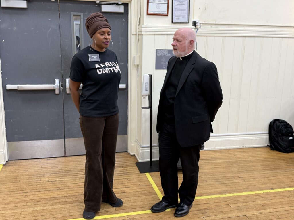 Monsignor Kevin Sullivan (right), executive director of Catholic Charities of the Archdiocese of New York, talks with Electra Weston, founder of the International Child Program (ICP), on November 19, 2024, during a visit the Lt. Joseph P. Kennedy Jr. Community Center in Harlem.