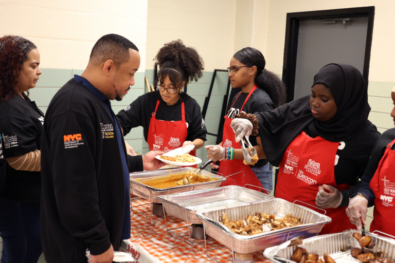 Bobby Gates, Program Director for Youth Appointment Program in Alianza, waits until the end of the event to get in line and see how the students work the buffet for himself.