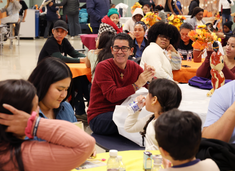 The crowd applauds after Alianza Director Eddie Silverio’s speech before the food is served.