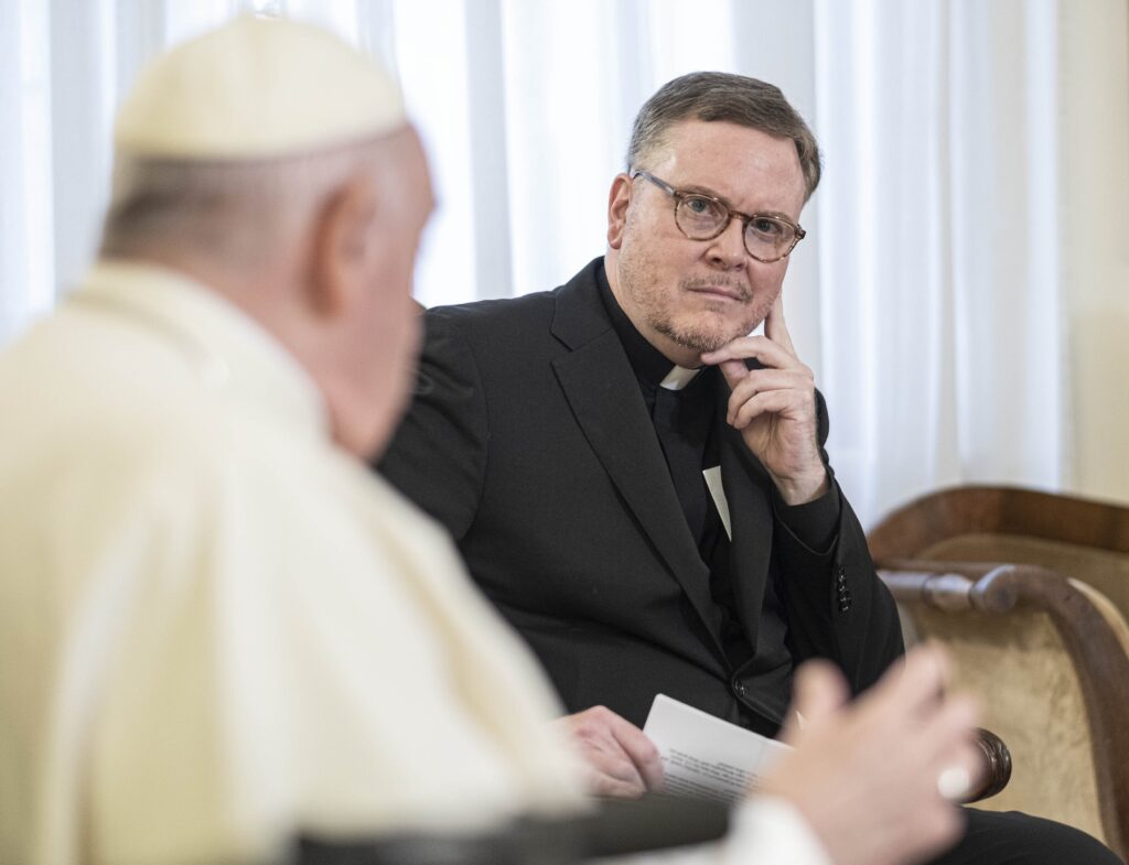 Jesuit Father Matt Malone, outgoing editor-in-chief of America Magazine, listens during an interview with Pope Francis at the Vatican November 22, 2022.