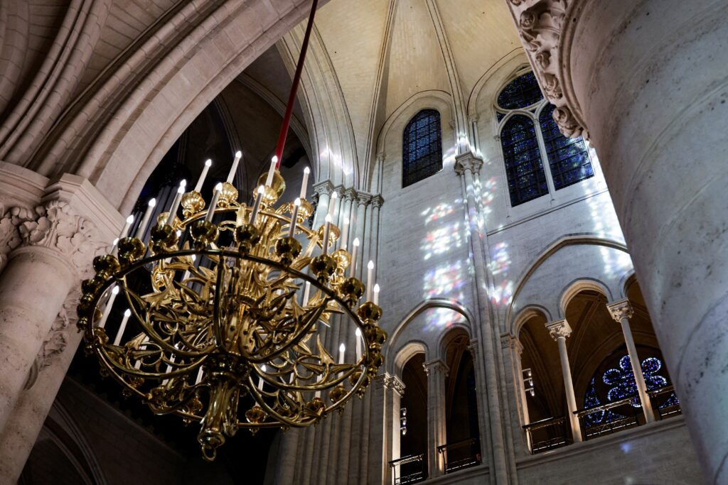 An electric candelabra hangs from the ceiling inside Notre Dame Cathedral in Paris November 29, 2024.