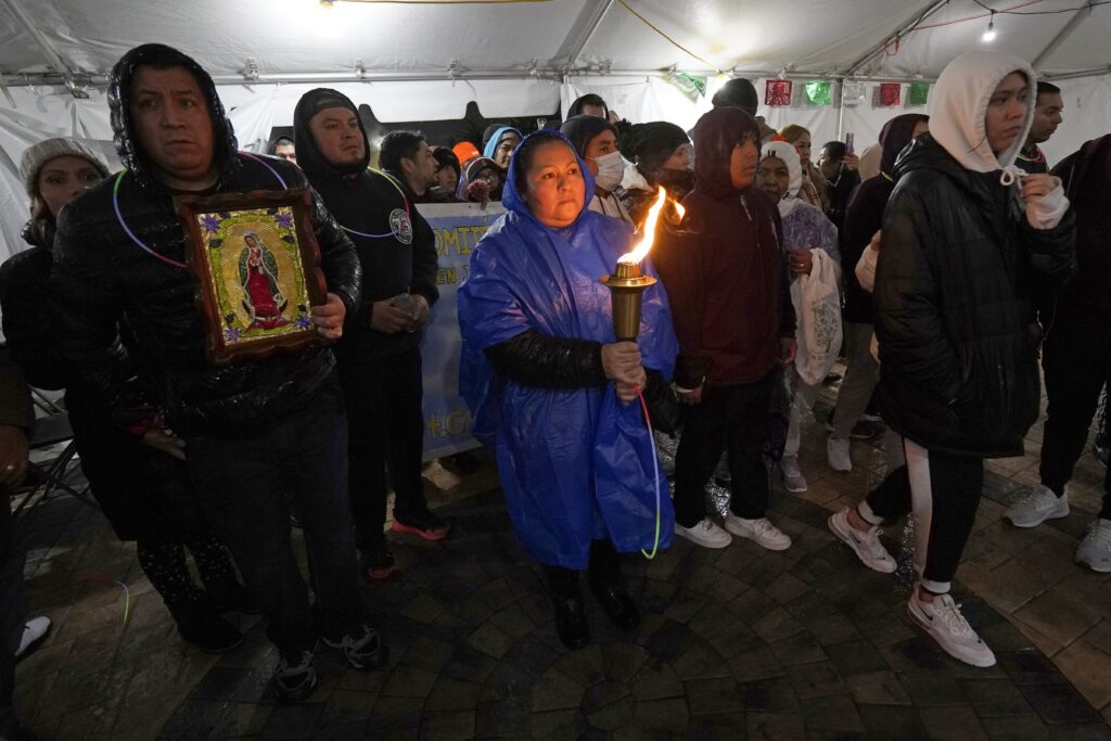 A participant in the annual Guadalupe Torch Race ("Carrera Antorcha Guadalupana") arrives at Our Lady of Mount Carmel Church in Staten Island, on December 11, 2022, the eve of the feast of Our Lady of Guadalupe.