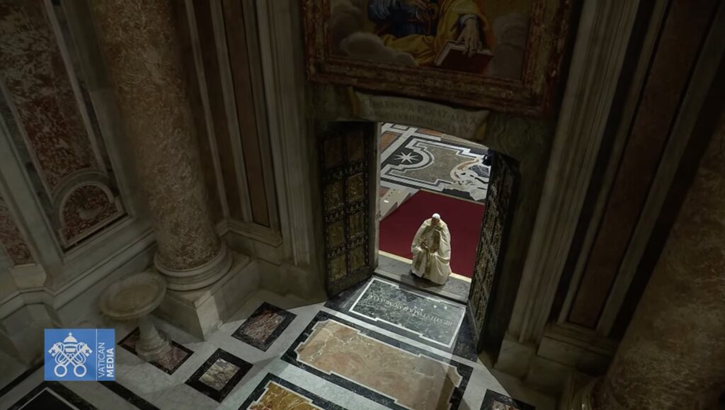 Pope Francis pauses in prayer on the threshold of the Holy Door of St. Peter's Basilica at the Vatican on December 24, 2024, after he opened it and inaugurated the Holy Year 2025.