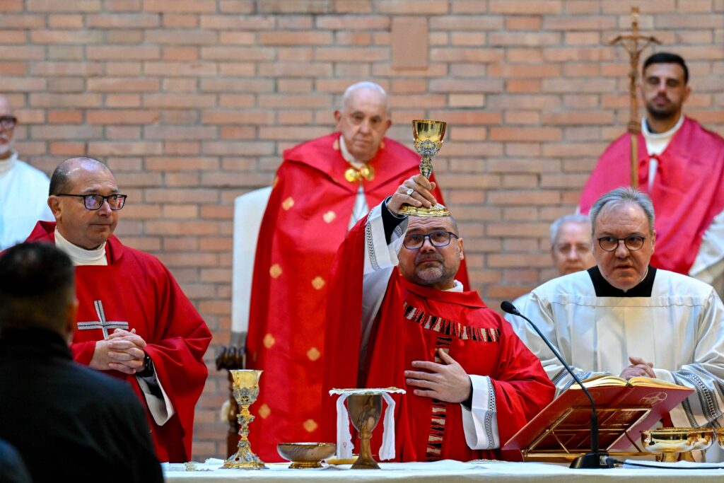 Pope Francis presides over Mass with inmates, prison staff, and Italian government officials at the Church of Our Father in Rome’s Rebibbia prison December 26, 2024, after opening the Holy Door of the church.