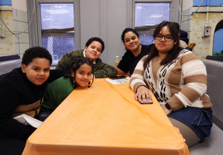 A family poses for the camera as they enjoy the event before the food is served.