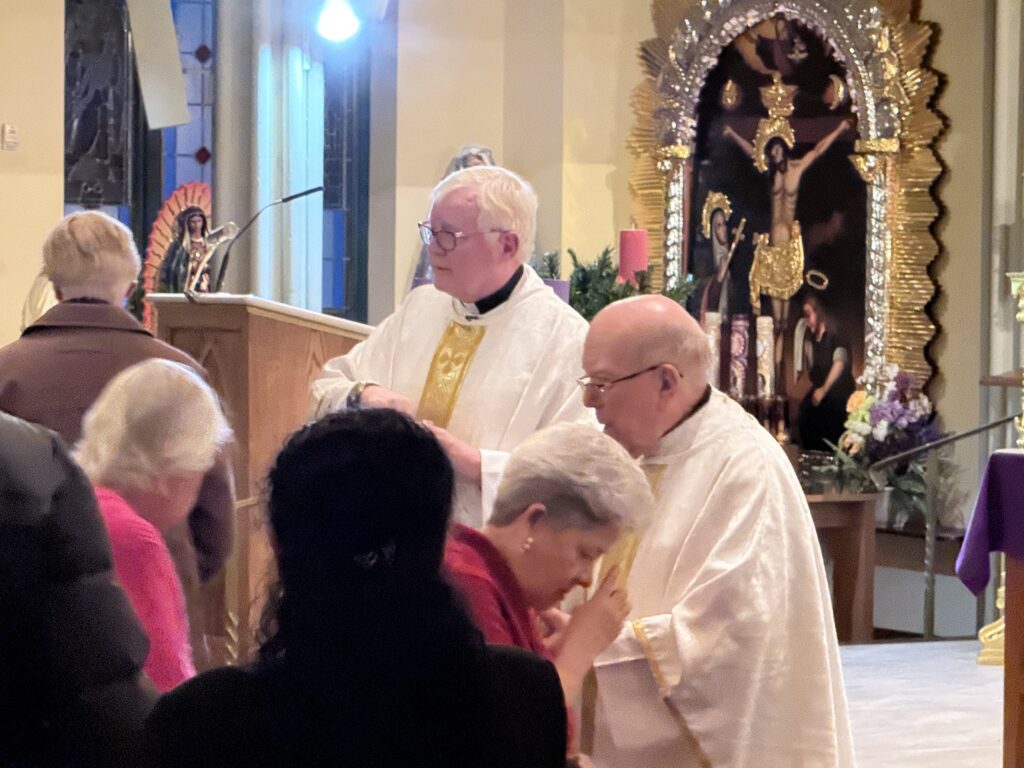 Monsignor Kevin Nelan (center) and Father Francis McGourn distribute communion during the Church of St. Bridgid’s 175th anniversary Mass, November 30, 2024.