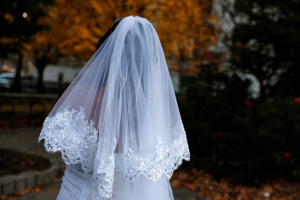 A bride in New York City stands in a park across the street from the Manhattan Marriage Bureau November 18, 2021.