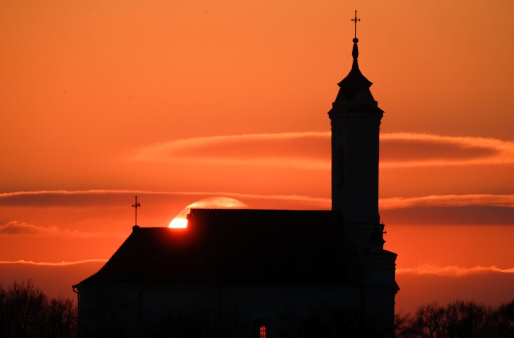 A Catholic church is silhouetted during sunset in Zaslavl, Belarus, April 10, 2019.