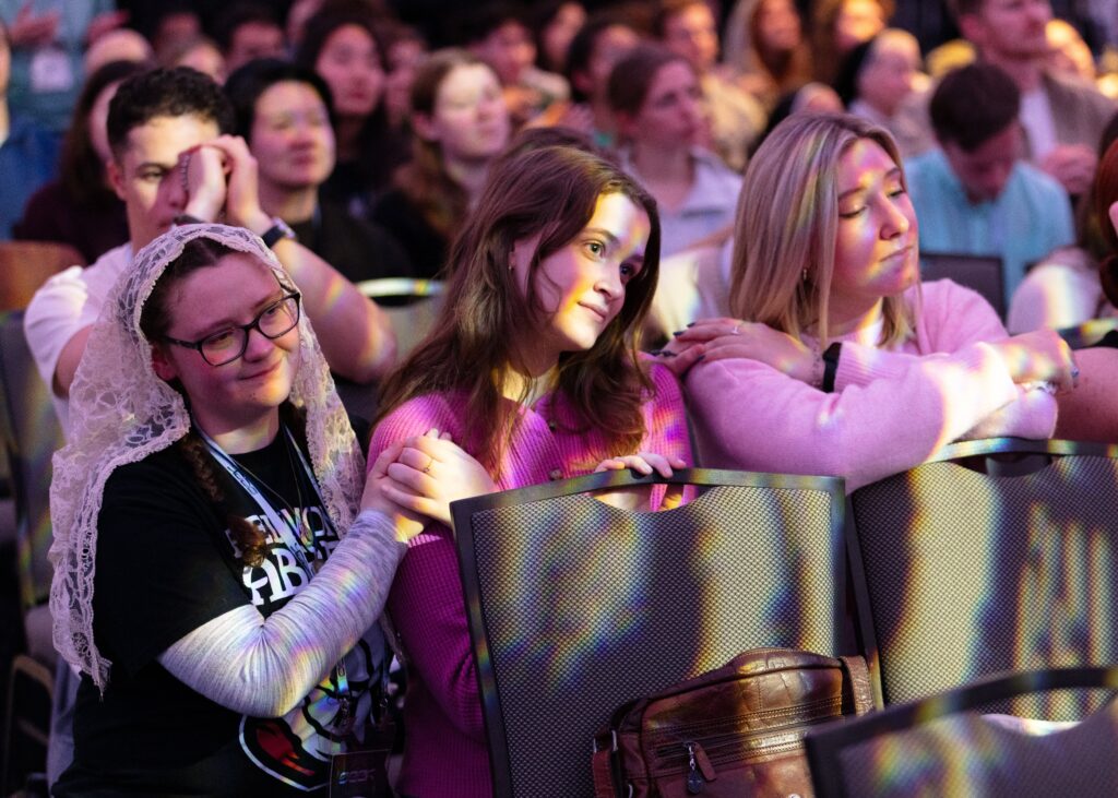 Attendees are seen kneeling in prayer during SEEK25 in Washington January 3, 2025.