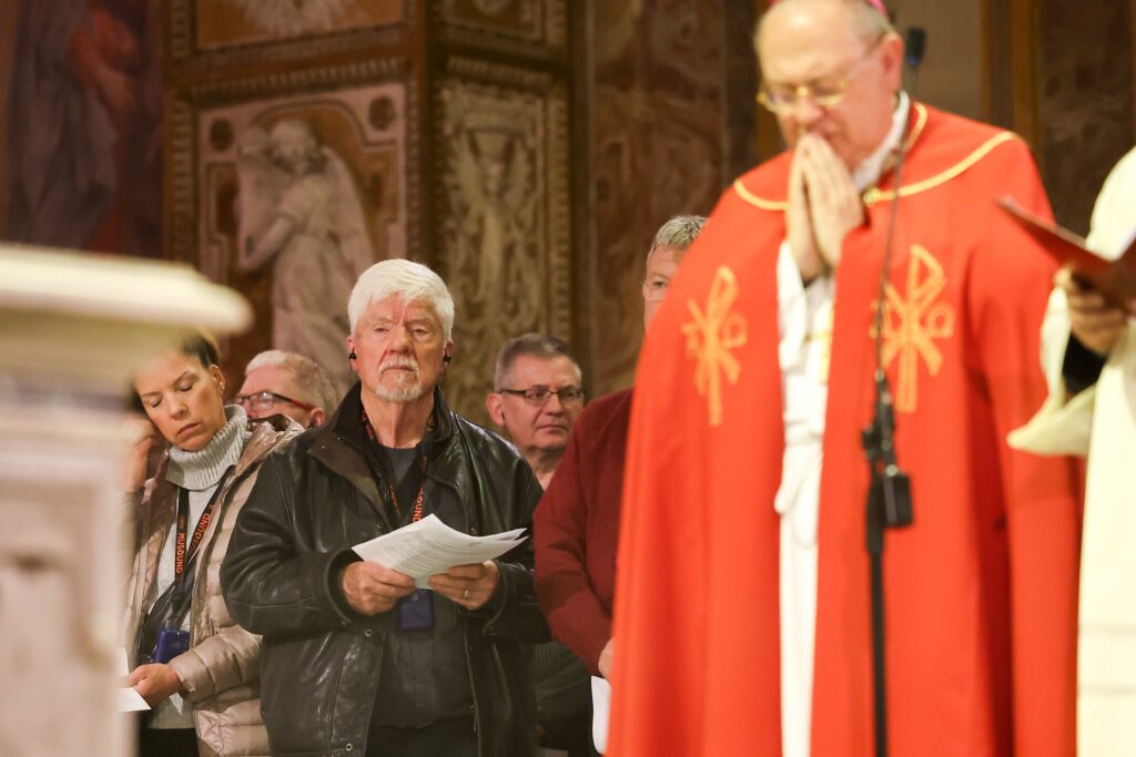 Tom Stang, left, brother of U.S. Notre Dame de Namur Sister Dorothy Stang, stands in silence as Archbishop Fabio Fabene, secretary of the Dicastery for the Causes of Saints, prays during a service honoring his sister at the shrine of new martyrs in the Basilica of St. Bartholomew on Tiber Island in Rome January 10, 2025.