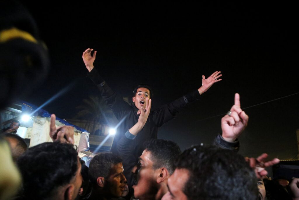 Palestinians in Khan Younis, in the southern Gaza Strip, react to news on a Hamas ceasefire deal with Israel January 15, 2025.