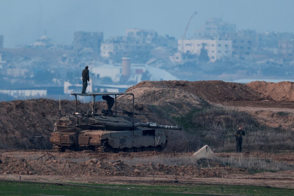 Israeli soldiers, seen from the Israel's side of the border with Gaza, stand on a tank ahead of a ceasefire agreement between Israel and Hamas January 15, 2025. (OSV News photo/Amir Cohen, Reuters)