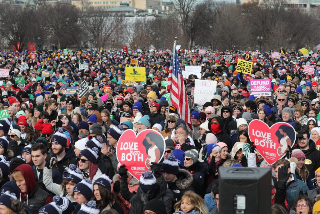 People hold signs during the 52nd annual March for Life rally in Washington on January 24, 2025.