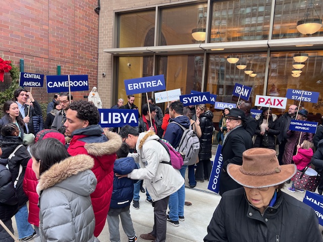 Participants in the Church of Our Saviour's March for Peace gather, carrying the names of countries currently in conflict, January 1, 2025.