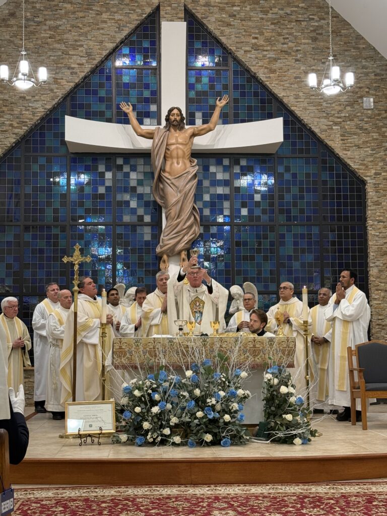 Cardinal Timothy Dolan (center) lifts the chalice during Mass at the Shrine Chapel of Our Lady, Help of Christians in Stony Point, New York, on January 30, 2025.