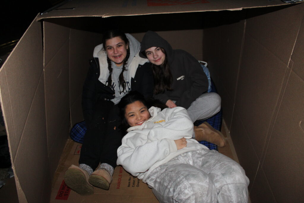 Three Maria Regina High School students participate in the school's annual Box City initiative in support of unhoused persons, January 10, 2025.