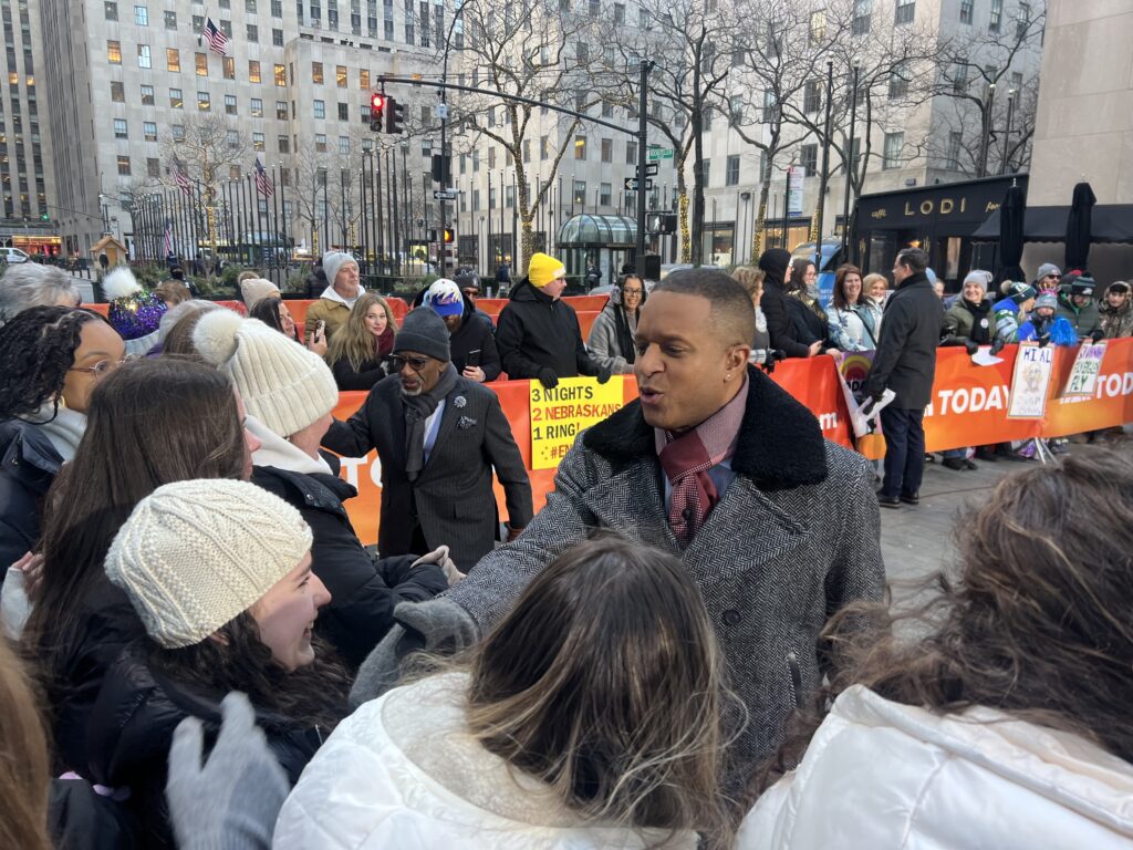 "The Today Show" presenters Craig Melvin (center) and Al Roker greet Maria Regina High School students gathered on the street outside the show's windows in Rockefeller Center in January 2025.