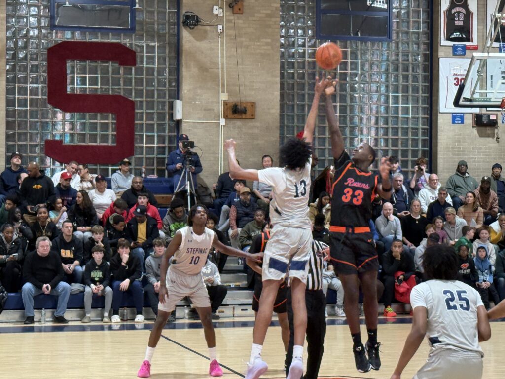 Archbishop Stepinac's Darius Ratliff (13) and St. Raymond's Ibrahima Camara (33) jump for the ball at the start of the Friday, January 17, game.