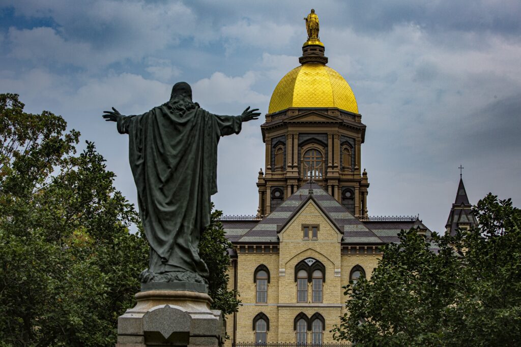 A statue of Jesus facing the Golden Dome with its statue of Mary atop the administration building of the University of Notre Dame in Notre Dame, IN, is seen August 6, 2021. Photo: OSV News photo/Chaz Muth