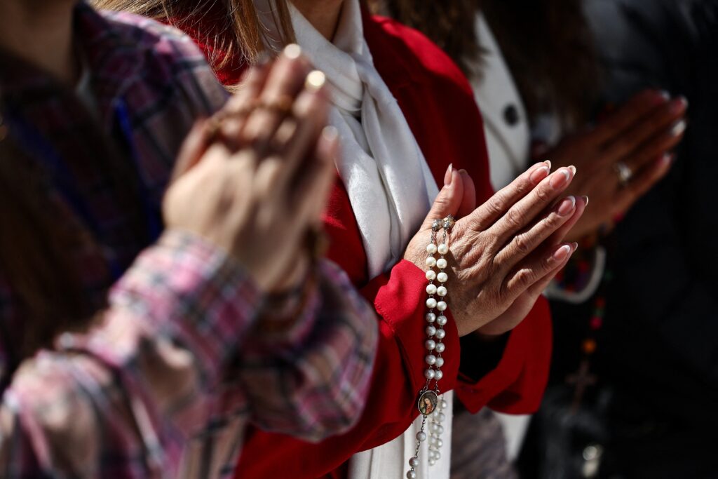 People pray outside Rome's Gemelli Hospital February 27, where Pope Francis was admitted for treatment February 14. (OSV News photo/Yara Nardi, Reuters)