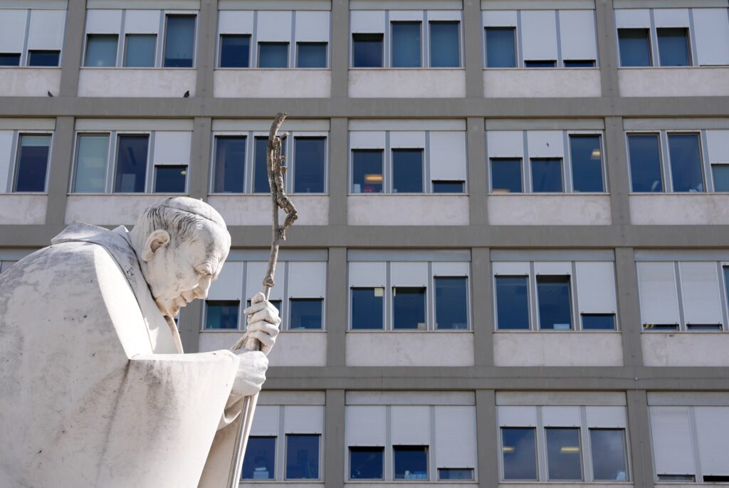 A statue of St. John Paul II stands outside Rome’s Gemelli hospital February 27, 2025, while Pope Francis receives treatment for double pneumonia. (CNS photo/Lola Gomez)