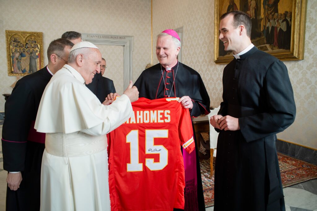 Pope Francis gives a thumbs up as he looks at a football jersey presented by Bishop James V. Johnston Jr. of Kansas City-Saint Joseph, Missouri, during a meeting with U.S. bishops from Iowa, Kansas, Missouri, and Nebraska during their "ad limina" visits to the Vatican January 16, 2020.