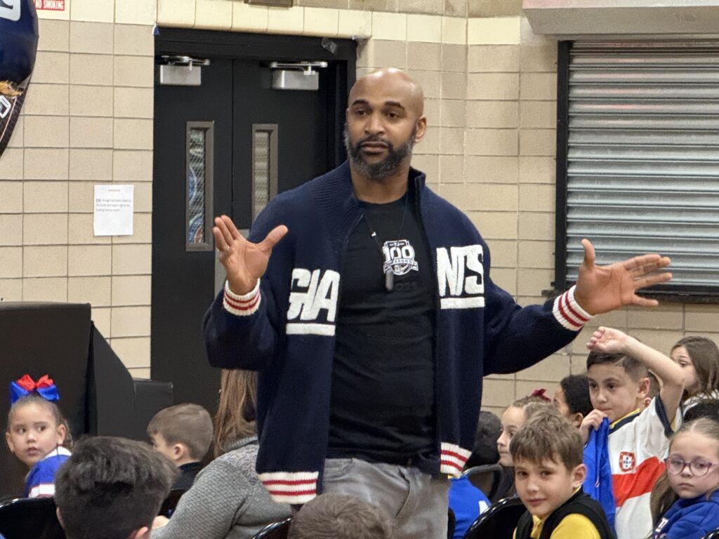 Former New York Giants player David Tyree speaks to students of St. Clare of Assisi School during a visit to the Bronx school on February 6, 2025.