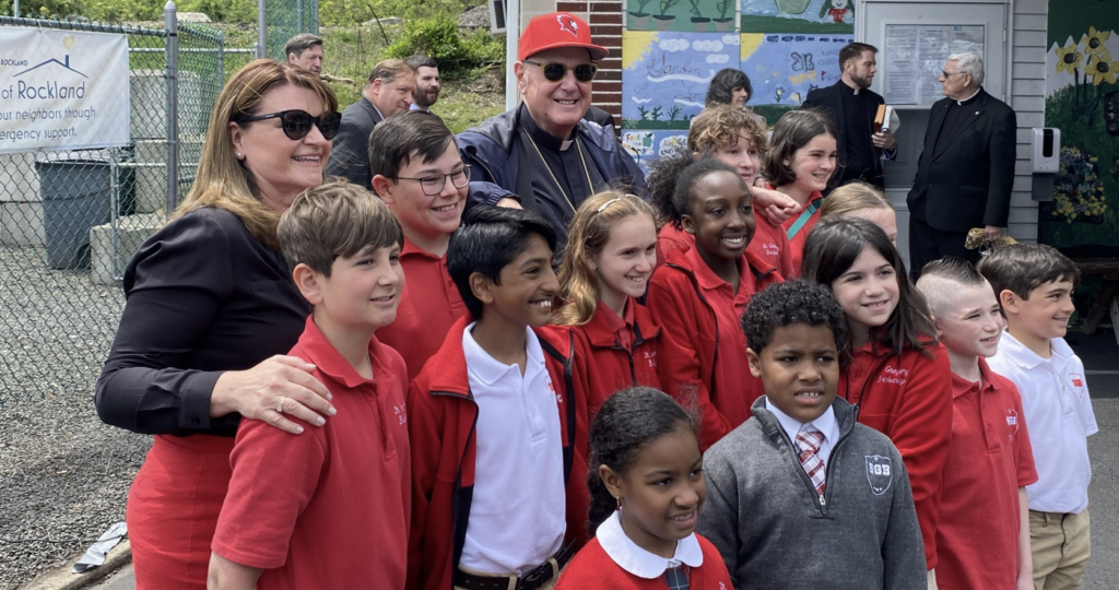 Cardinal Timothy Dolan (with baseball cap) poses with students and a teacher from St. Gregory Barbarigio School in Garnerville, May 4, 2024.