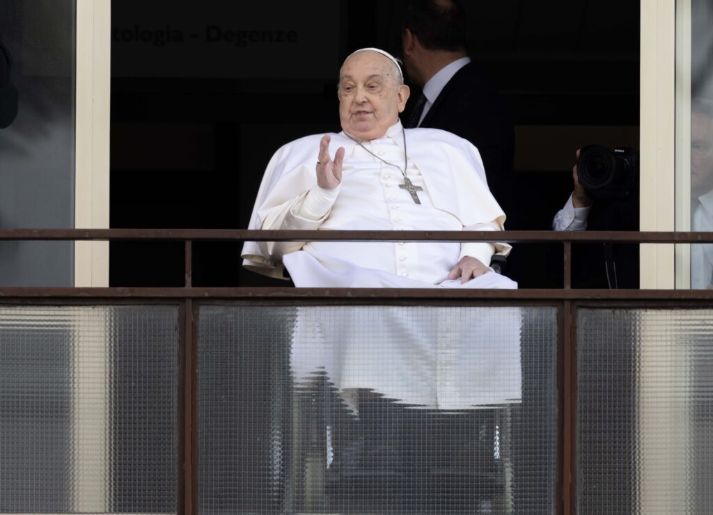 Pope Francis waves to a crowd of well-wishers at Rome's Gemelli hospital before returning to the Vatican March 23, 2025, after 38 days of treatment at the hospital.